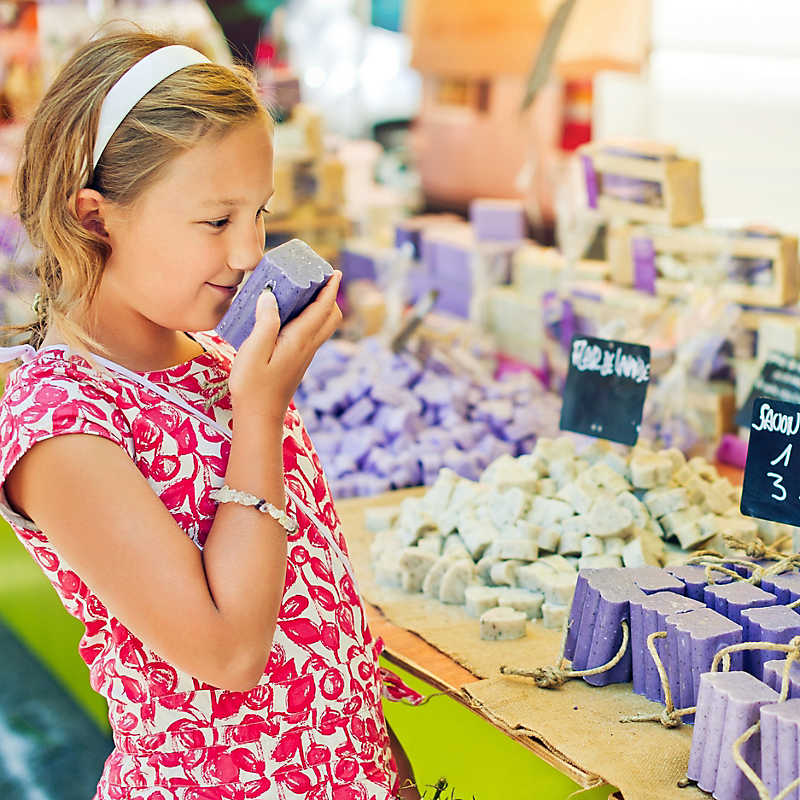 child sniffing soap at a market