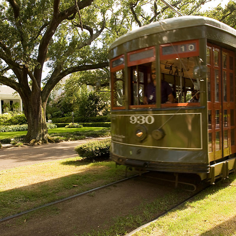 People on green trolley while on Garden District Tour