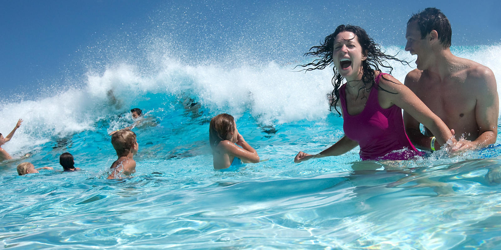 Couple and kids in wave pool