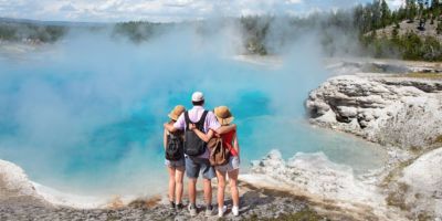 Family on hiking trip viewing beautiful scenery at Yellowstone National Park
