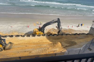 DOL dolphin beach club temporary ocean seawall installation bull dozer