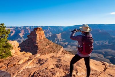 arizona south rim of grand canyon woman taking photo of view