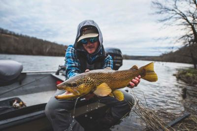 arkansas white river trout club fisherman boat holding fish