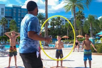 associate playing hula hoop with kids resort activity