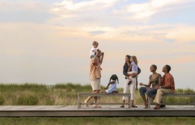 Family and Friends gathering on deck watching the sunset