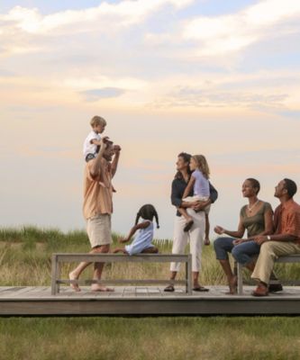 Family and Friends gathering on deck watching the sunset