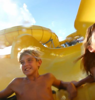 Kids sliding down water slide