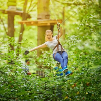 Female ziplines through California Big Bear Lake