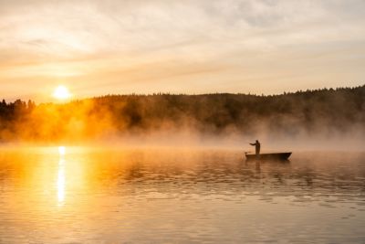 canada quebec lake of lanaudiere man fly fishing on boat
