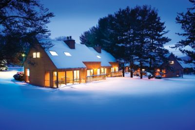 Christmas Mountain Village snowy cabin at night