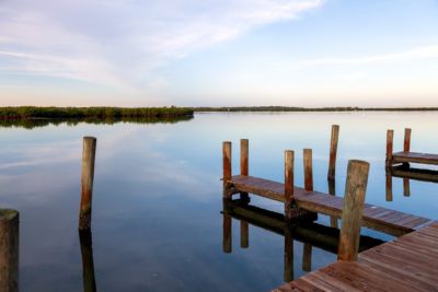 fishing pier lake under blue sky
