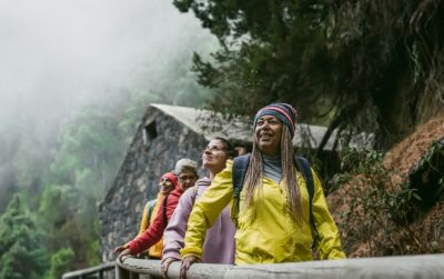 group of women walking foggy forest