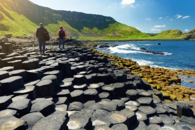 ireland tourists walking giants causeway hexagonal basalt stones