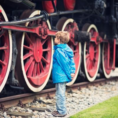 boy staring at a steam locomotive