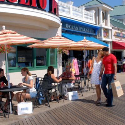 Couple walking along Boardwalk facade