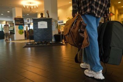 person checking in with luggage guest arrival