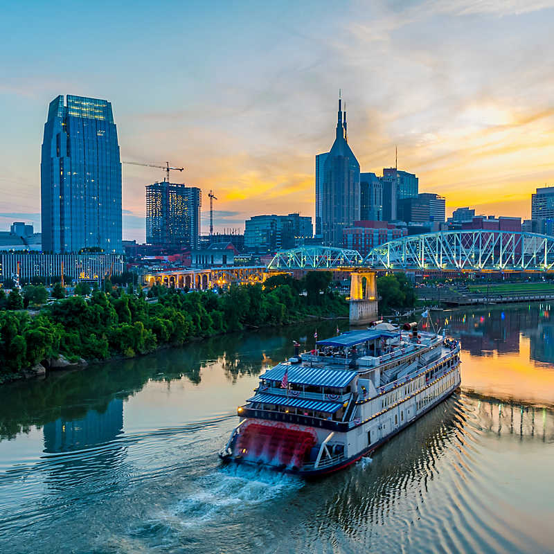Nashville, Tennessee's skyline at night with riverboat