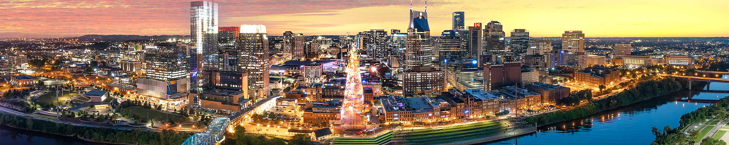 Nashville, Tennessee's skyline with Cumberland river in view at sunset